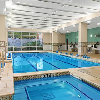 A beautifully designed indoor swimming pool area, perfect for leisure and exercise.