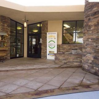 The entrance to a building featuring a stone facade and glass doors.