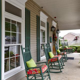 A welcoming porch with rocking chairs and colorful cushions.