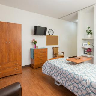 A well-designed hospital room featuring wooden furniture and a cozy atmosphere.