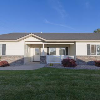 A charming suburban house with a well-maintained front yard and inviting entrance.