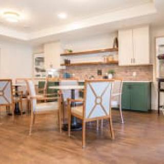A modern kitchen with a dining area and stylish furniture.