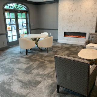 A cozy and modern living room featuring a contemporary fireplace and comfortable seating arrangements.