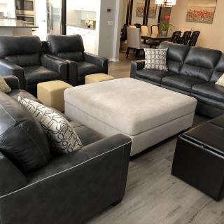A modern living room with stylish sofas and a central coffee table.
