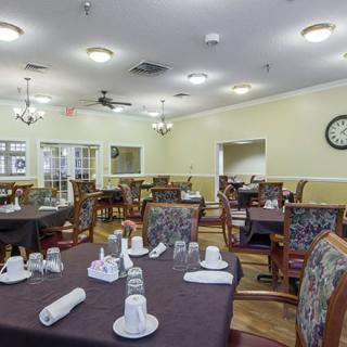 An elegant dining room with neatly set tables and comfortable chairs.