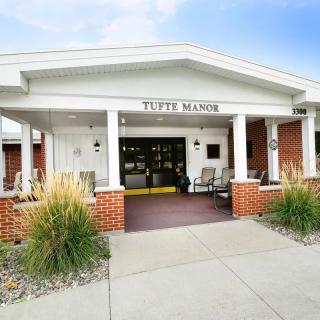 Front entrance of a retirement home with a welcoming patio.