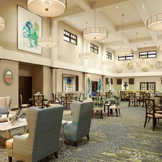A modern dining area with comfortable seating and elegant lighting fixtures.