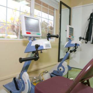 A rehabilitation center featuring stationary exercise bikes equipped with digital displays.
