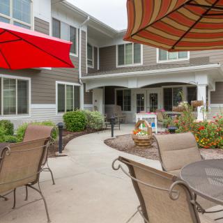 A cozy patio area with outdoor seating and umbrellas in a residential setting.