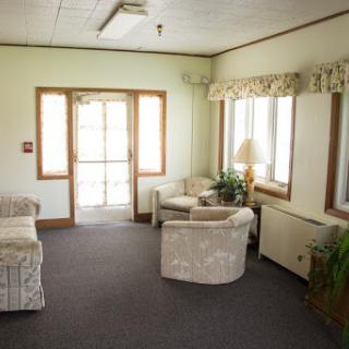 A cozy lounge area filled with soft seating and natural light, perfect for relaxation.