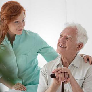A caregiver offering support and companionship to an elderly man.