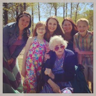A family enjoying a sunny day together outdoors, capturing smiles and warm moments.