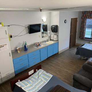 A hospital room with a patient bed, sink, and medical equipment.