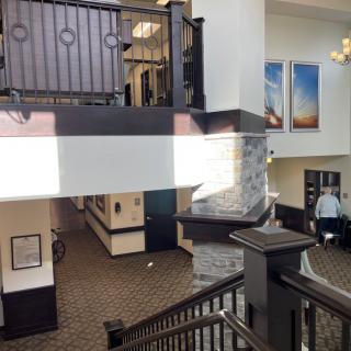 Hotel lobby interior with a staircase and chandelier.