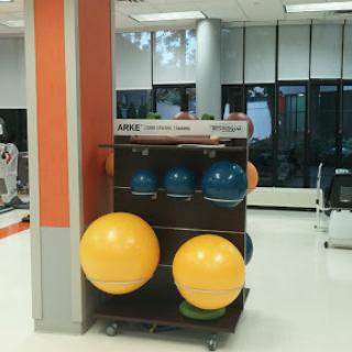 A display of colorful exercise balls and fitness equipment in a gym or therapy center.