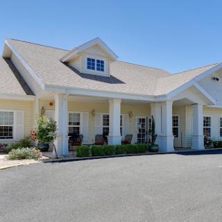 A charming two-story residential building with a welcoming front entrance.
