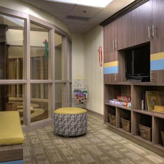 A cozy children's waiting area featuring comfortable seating and playful decor.
