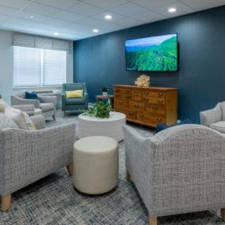 A modern and cozy living room with comfortable seating, a flat-screen TV, and stylish decor.