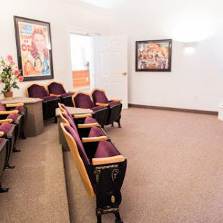 A modern waiting room featuring comfortable seating and vibrant artwork on the walls.