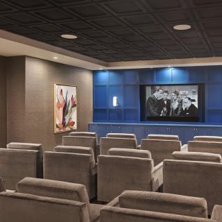 A modern home theater with comfortable seating and a large screen for an immersive viewing experience.