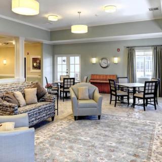 A spacious and elegantly decorated living room with comfortable seating and soft lighting.