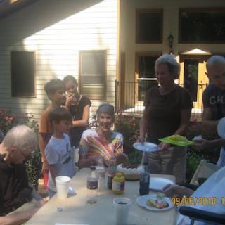 Family enjoying an outdoor gathering on a sunny day.