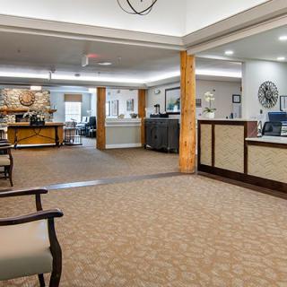 A spacious lobby with a reception desk and comfortable seating areas.