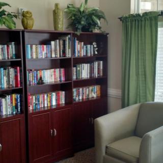 A cozy reading corner with a well-stocked bookshelf and a comfortable armchair.