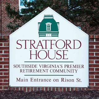 A sign for Stratford House, a premier retirement community in Southside Virginia, indicating the main entrance on Rison St.