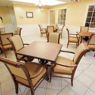 Empty dining area with several tables and chairs arranged neatly.