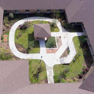 Aerial view of a courtyard with winding pathways and landscaped gardens.