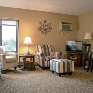 A cozy living room with striped furniture and warm lighting.