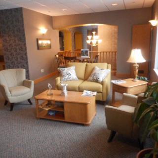 A cozy living room with comfortable seating and warm lighting.
