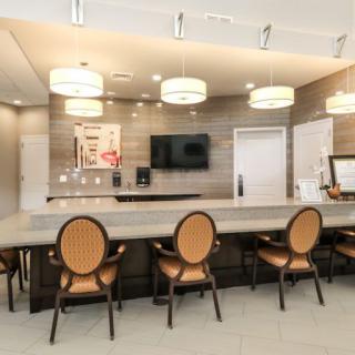 A modern kitchen interior with a sleek counter and elegant seating.