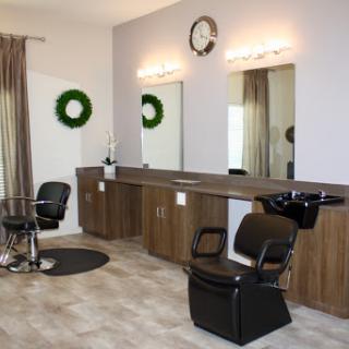 A stylish and modern hair salon featuring comfortable seating, well-lit mirrors, and a welcoming aesthetic.