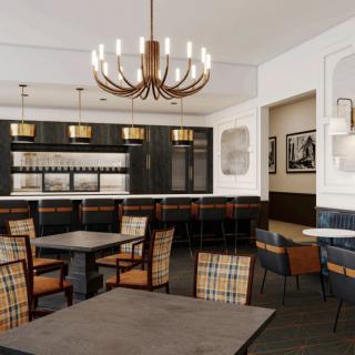 A modern restaurant interior featuring a stylish chandelier and dining area.