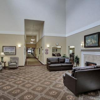 A spacious lobby area featuring comfortable seating and a cozy fireplace.