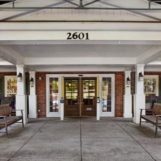 Front entrance of a building with benches and clearly visible address number 2601.