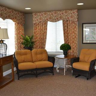 A cozy living room with a sofa, armchair, and decorative elements.