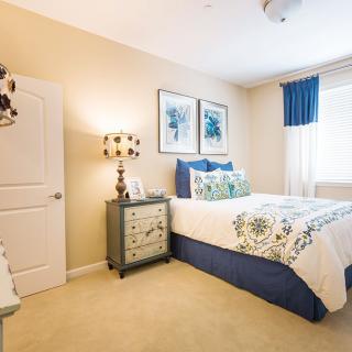 A cozy bedroom with elegant decor and a well-made bed.