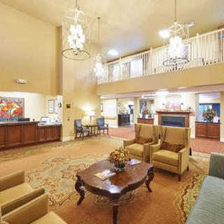Spacious lobby with comfortable seating and elegant chandeliers.