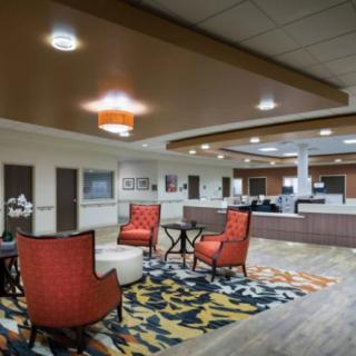 A modern lobby with comfortable seating and a reception desk.