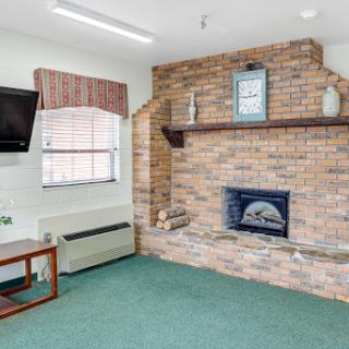 Cozy living room featuring a brick fireplace and modern furnishings.