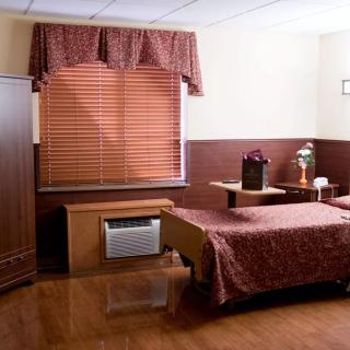 A cozy bedroom with wooden flooring and elegant furnishings.