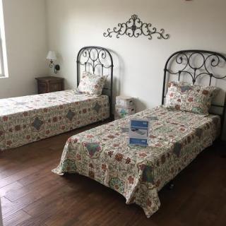 A cozy bedroom with two twin beds featuring patterned bedding.