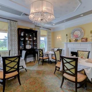 A beautifully designed dining room featuring elegant furniture and a charming chandelier.