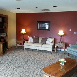 A cozy living room featuring a sofa, decorative lamps, and a coffee table.