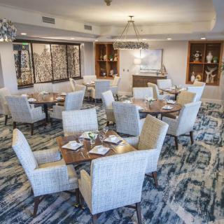 A modern dining room with neatly arranged tables and chairs in a stylish setting.