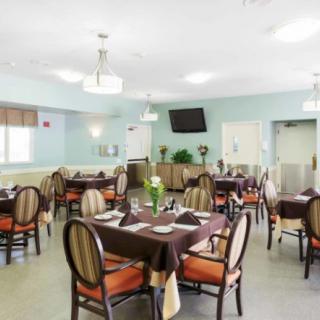 An elegantly designed dining room with neatly arranged tables and chairs.