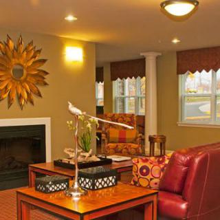 A cozy living room with warm lighting, featuring comfortable furniture and stylish decor.
